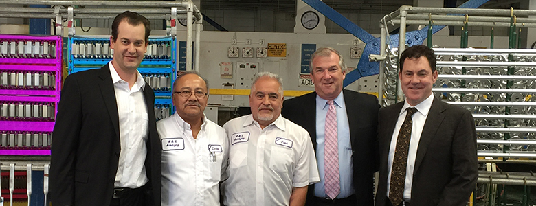Jose Toscano stands with other representatives of K&L and the aerospace and greater plating industry